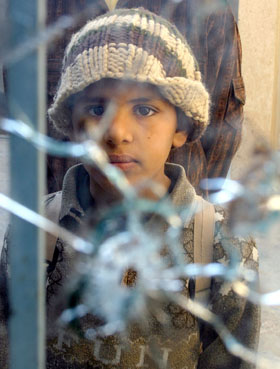 Un garçon regarde les fenêtres trouées de balles d'une mosquée de Baqouba. Les violences sectaires ont fait plusieurs morts dans cette ville depuis la fin du régime de Saddam Hussein.