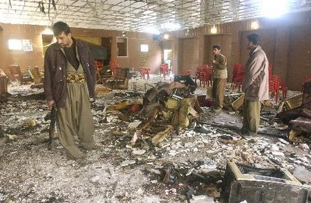 Peshmergas with the Kurdistan Democratic Party walk through the room inside the KDP headquarters in Irbil